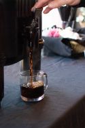 close up of pouring coffee into a cup